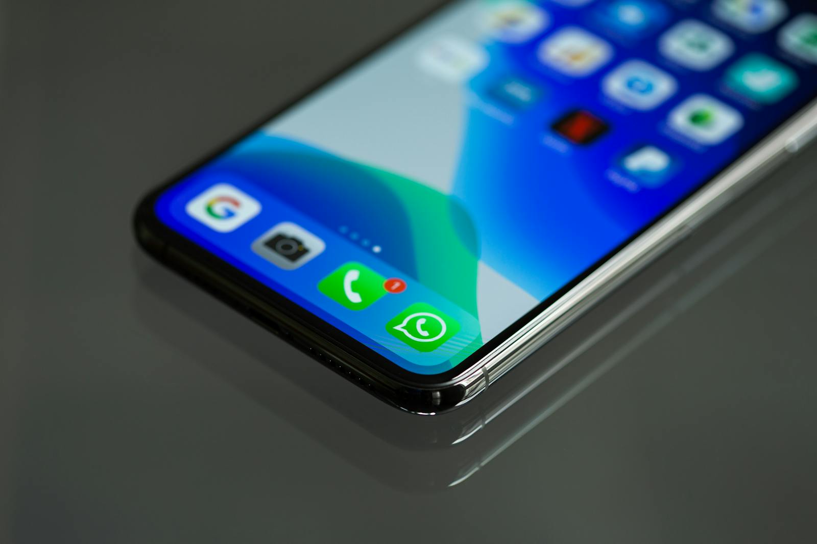 Close-up shot of a smartphone screen displaying various app icons including WhatsApp.